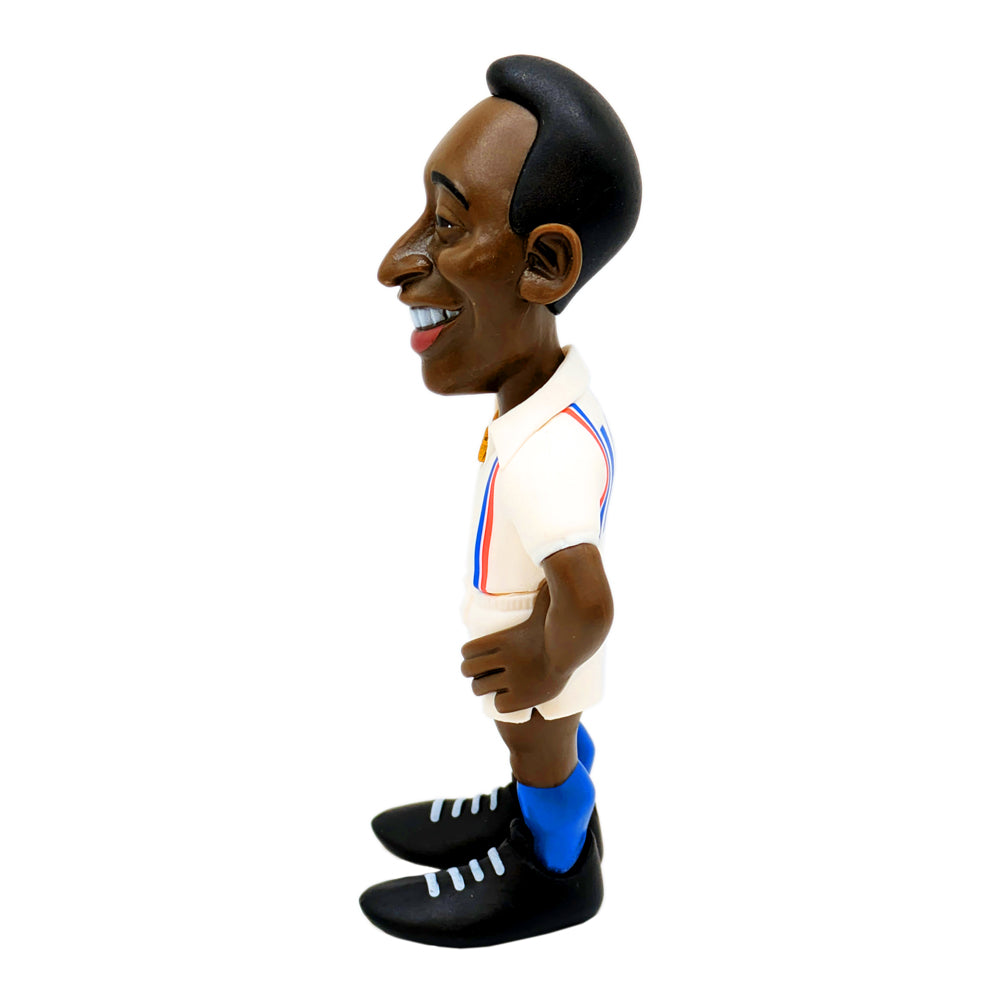 Football figurine, Minix Pelé Escape to Victory Edition, wearing a white kit with red and blue trim, blue socks and black boots.