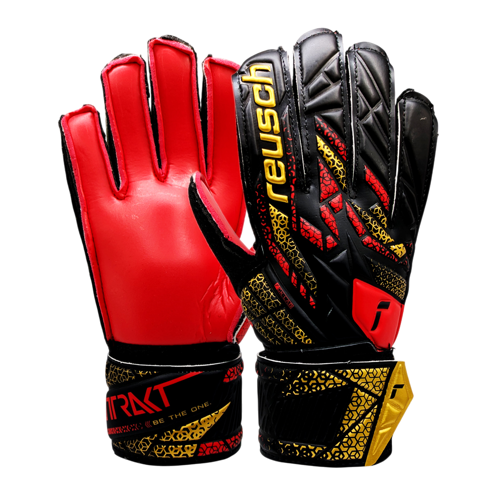 Reusch Attrakt junior goalkeeper gloves with durable synthetic latex palm, red and black design, adjustable wrist strap, breathable backhand, and flexible thumb for artificial grass.