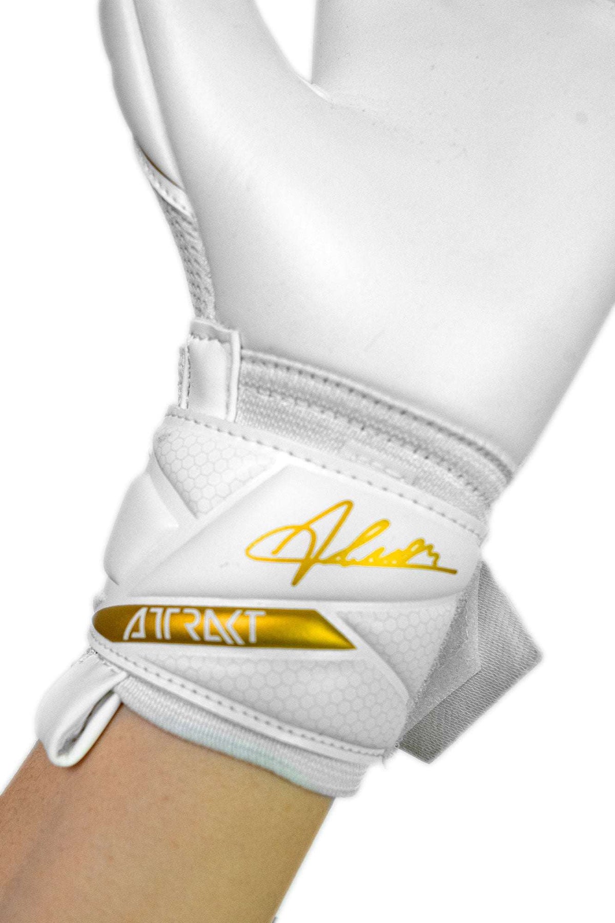 Reusch Attrakt AB1 junior goalkeeper glove in white textured latex, with gold accents and an adjustable wrist strap.
