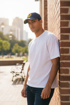 Man wearing Fan Ink officially licensed adjustable hat with team logo outdoors