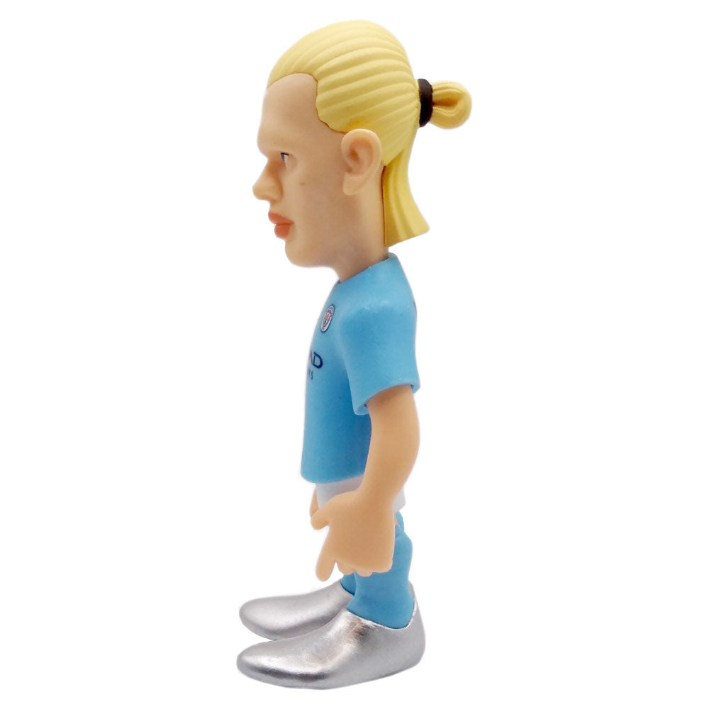 Minix Erling Haaland Manchester City figurine with a light blue kit, blond tied-back hair, and silver boots.