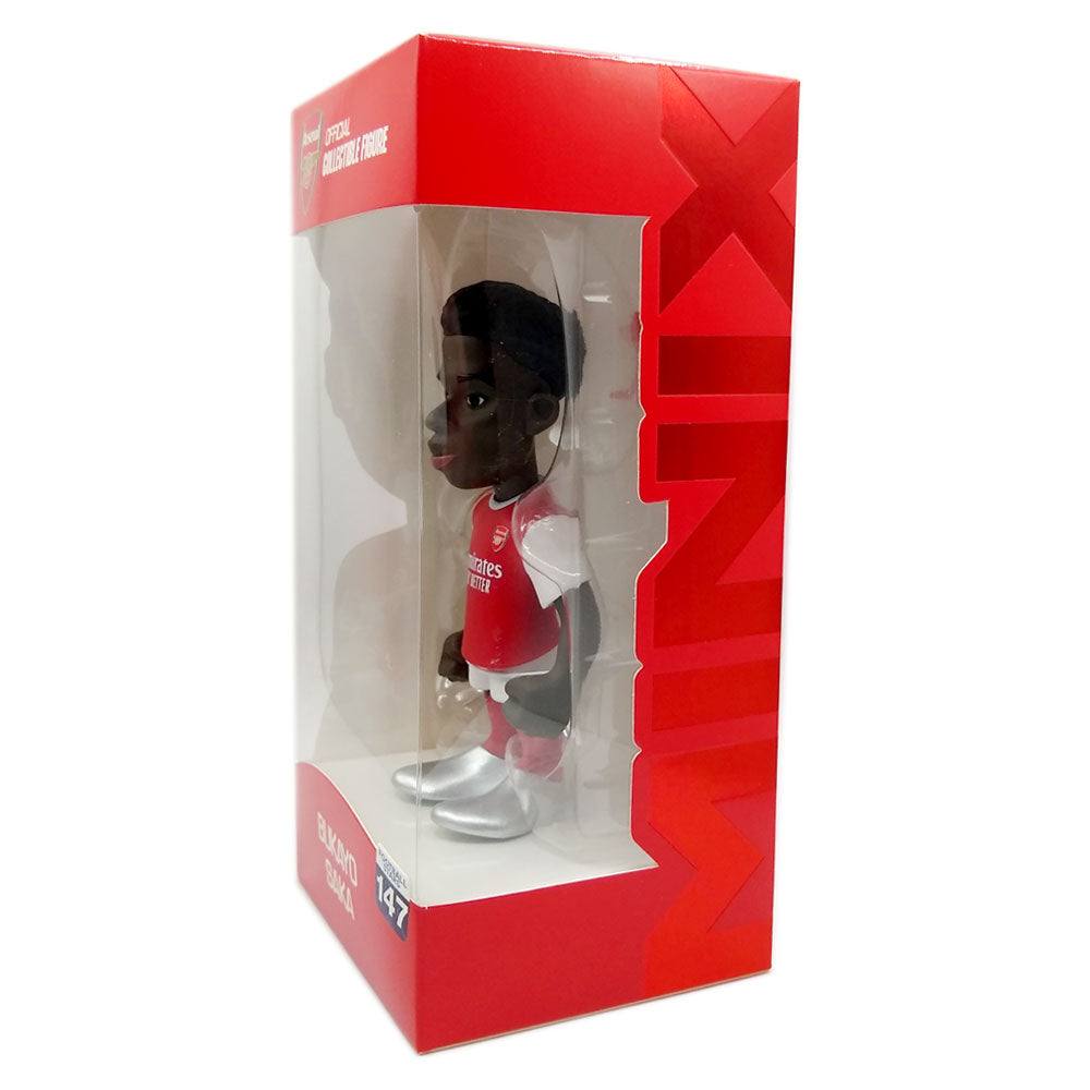 Minix Bukayo Saka Arsenal figurine with a brown sculpted face, red-and-white jersey, white shorts and oversized silver boots in a red display box.