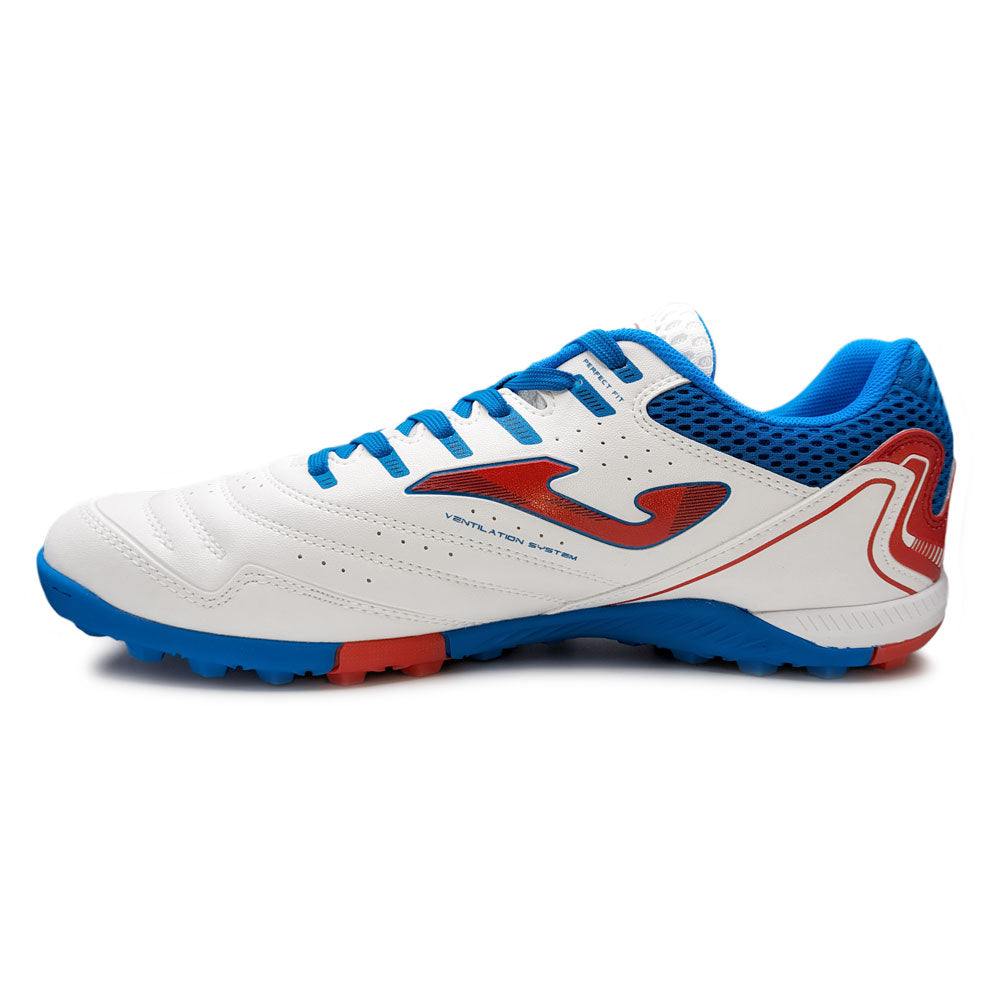 Joma Maxima turf soccer shoe in white with blue and red accents for adult players on artificial turf.