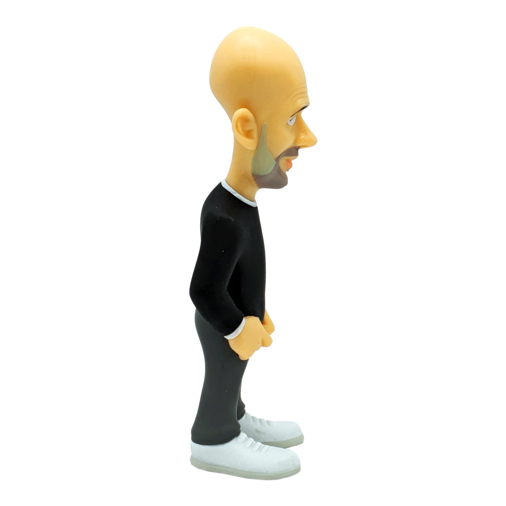 Minix Pep Guardiola Manchester City figurine with an oversized bald head, black sweater, dark trousers and white trainers.