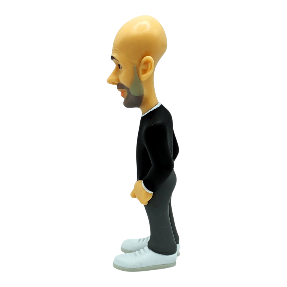 Collectible Minix Pep Guardiola Manchester City figurine with a bald head, dark suit, white shirt and white trainers.