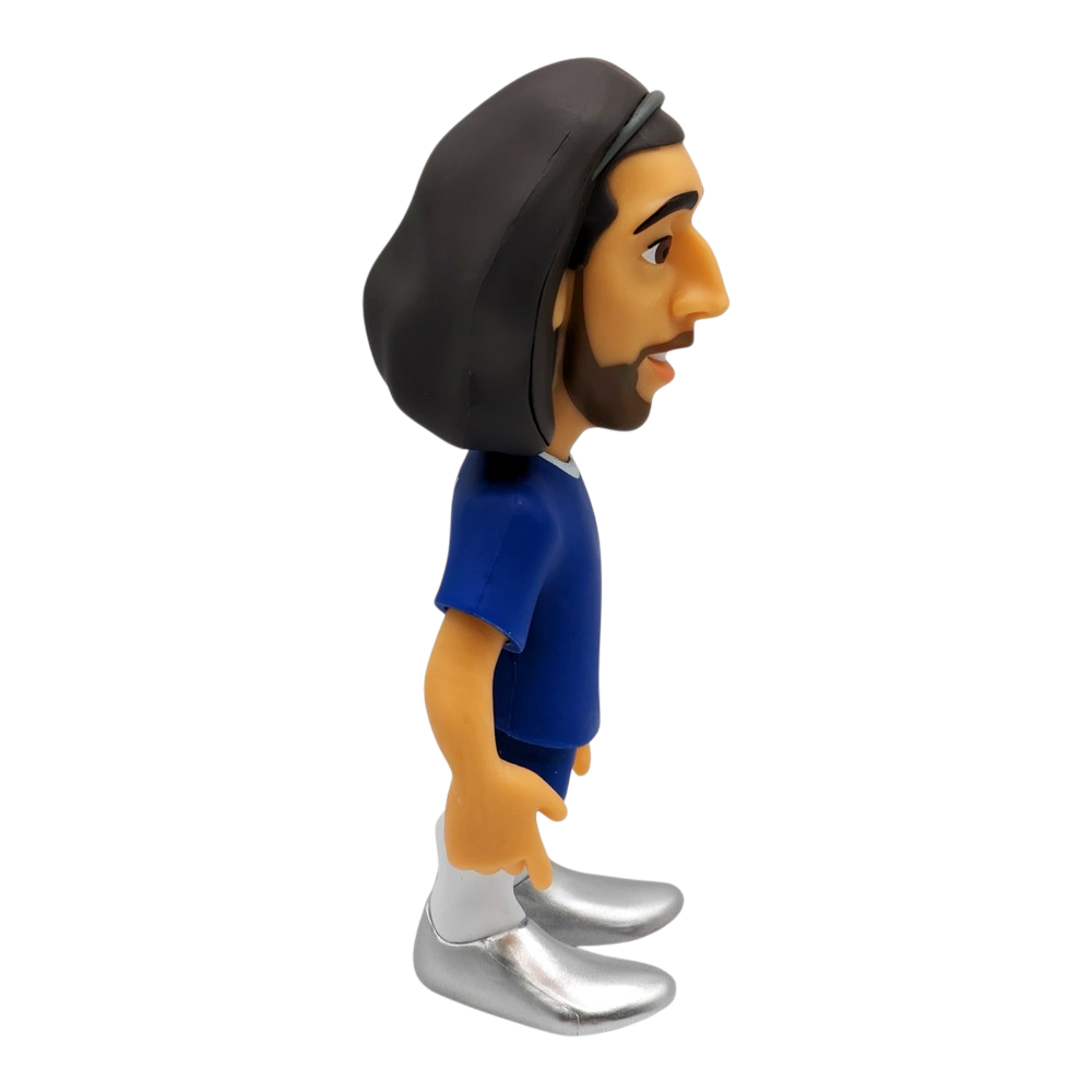Minix Marc Cucurella Chelsea figurine with long dark hair, a blue shirt, white socks and silver boots.