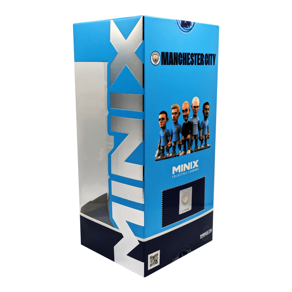 Minix Pep Guardiola Manchester City collectible figure in a bright blue display box, with team graphics and window panel.