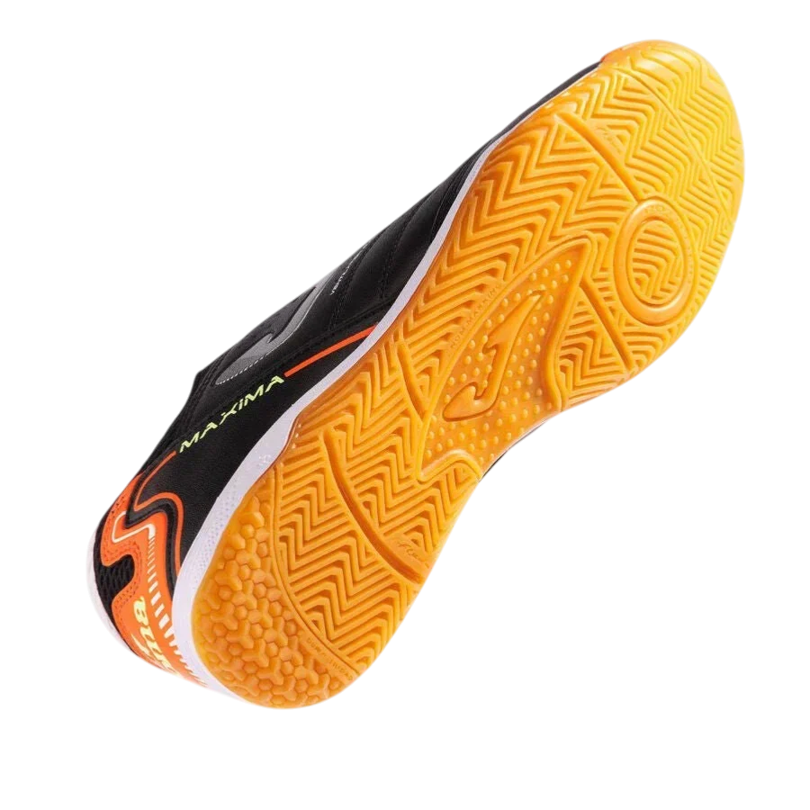 Joma Maxima indoor soccer shoe with black synthetic upper, orange accents and a bright yellow-orange textured rubber outsole