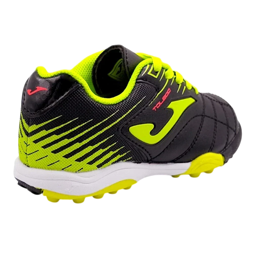 Joma Toledo turf soccer shoe in black with neon yellow-green accents, textured synthetic upper and rubber studs