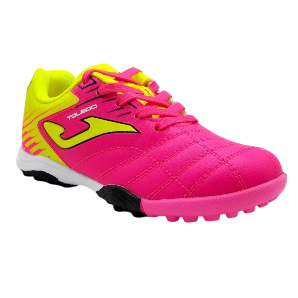 Joma Toledo turf soccer shoe in bright pink synthetic material with neon yellow accents, laces and rubber studs