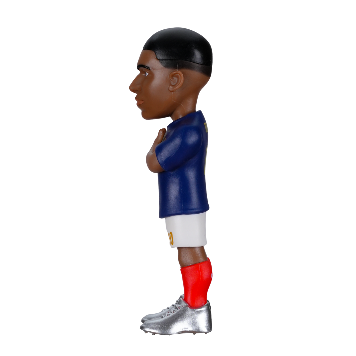 Minix Kylian Mbappé football figurine with dark skin, short black hair, blue shirt, white shorts, red socks and silver boots