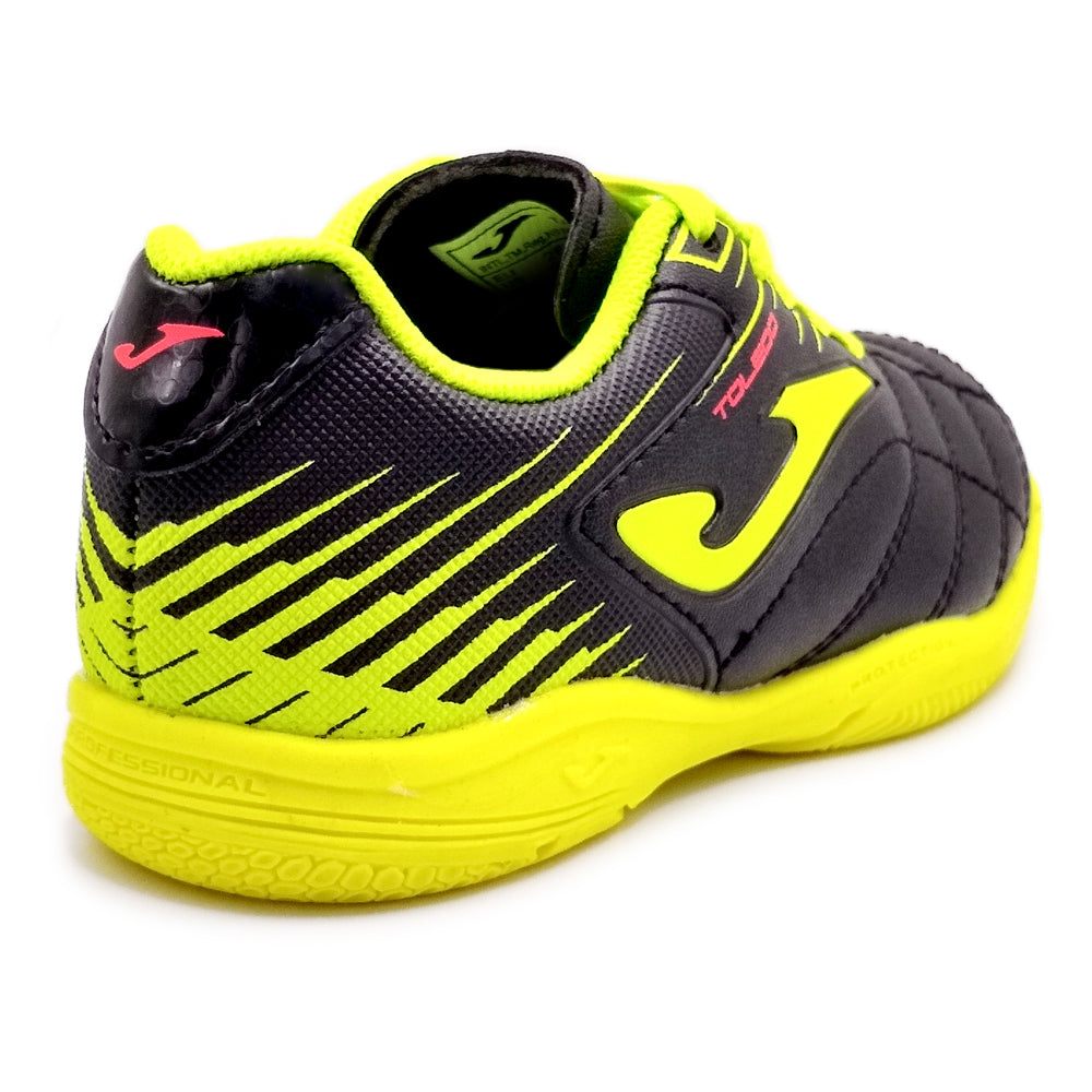 Joma Toledo Junior Indoor Soccer Shoes, stylish black and neon design, flexible sole for grip, perfect for young athletes.