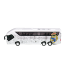 Real Madrid Mini Team Bus, white miniature coach with black windows, subtle gray pattern, and large club crest on the side.