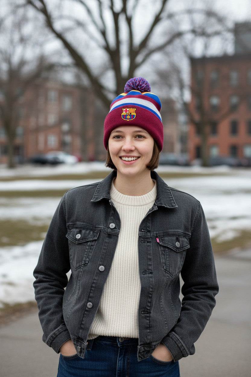 Young woman wearing Fan Ink officially licensed Barcelona soccer knit cap winter hat with club crest outdoors in cold weather
