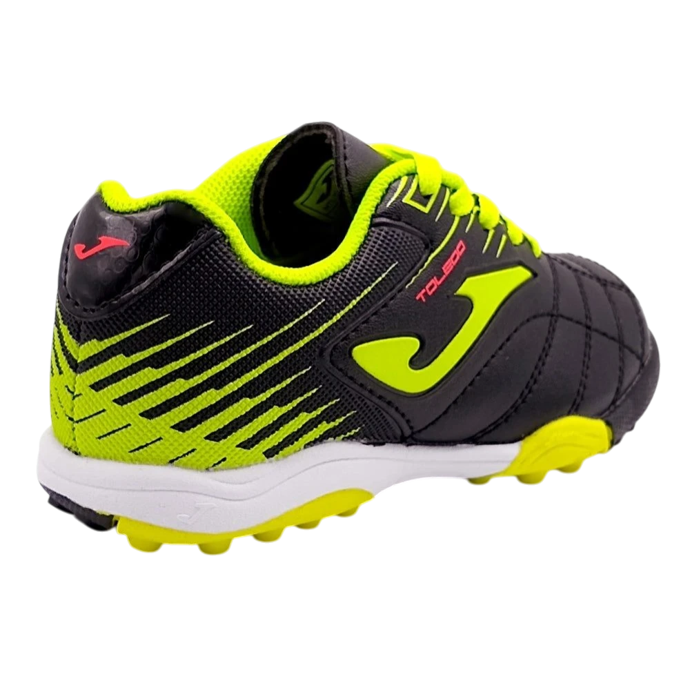 Joma Toledo Junior Kids Turf Soccer Shoes in black and neon green, designed for grip and comfort on artificial surfaces.