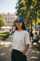 Woman wearing blue Fan Ink Officially Licensed Team Snapback Hat with Real Madrid embroidered logo outdoors