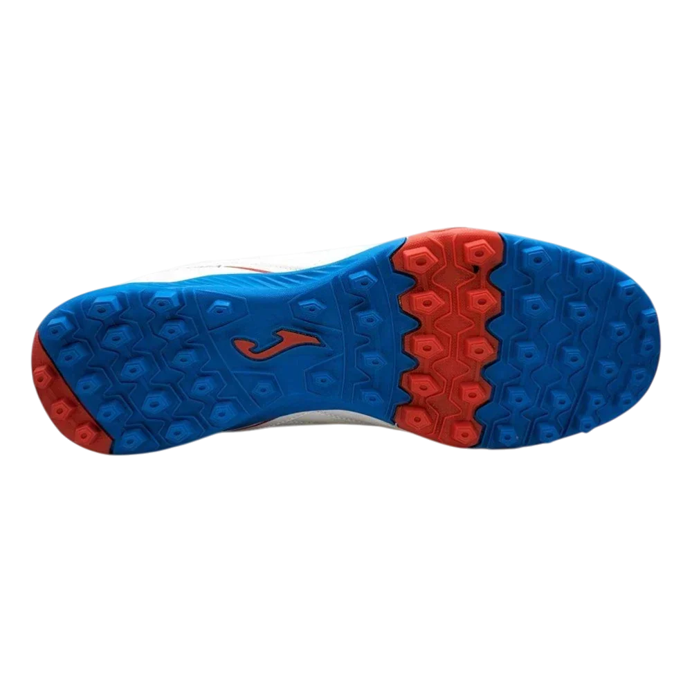 Joma Maxima turf soccer shoe outsole in blue and red rubber, featuring a dense pattern of multidirectional studs