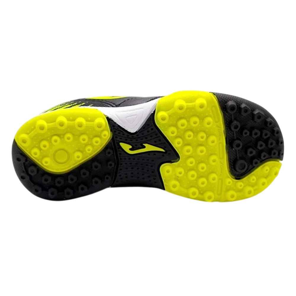 Joma Toledo turf soccer shoe outsole in black and neon yellow rubber, with rounded studs and textured grip zones