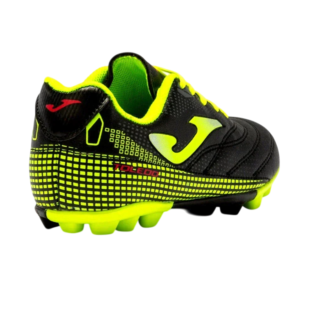Joma Toledo junior soccer cleat in black with neon yellow-green accents, textured upper, and molded studs