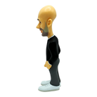 Minix Pep Guardiola Manchester City figurine with a large bald head, black suit, gray trousers, and white shoes.